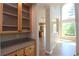 Hallway featuring beautiful cabinetry and hardwood floors leads to a bright, open living area at 5029 Preservation Pointe, Kennesaw, GA 30152