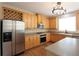 Well-equipped kitchen featuring stainless appliances, wood cabinetry, and tile backsplash at 5029 Preservation Pointe, Kennesaw, GA 30152