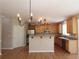 Charming kitchen features a breakfast bar, stainless steel appliances, and hardwood floors at 5029 Preservation Pointe, Kennesaw, GA 30152
