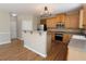 Bright kitchen with wooden cabinets, stainless steel appliances, and hardwood floors at 5029 Preservation Pointe, Kennesaw, GA 30152