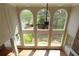 Sunlit living room with a wall of windows, ceiling fan, and hardwood flooring at 5029 Preservation Pointe, Kennesaw, GA 30152