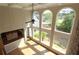 Sunlit living room with a wall of windows, ceiling fan, and hardwood flooring at 5029 Preservation Pointe, Kennesaw, GA 30152