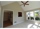 Sunroom with tile flooring, large windows, and doorway view into the kitchen at 5029 Preservation Pointe, Kennesaw, GA 30152