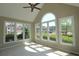 Bright sunroom with tiled floor, vaulted ceiling, and expansive windows with neighborhood views at 5029 Preservation Pointe, Kennesaw, GA 30152