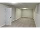 Clean basement area boasts neutral carpet, painted walls, and updated light fixtures at 64 Little John Way, Douglasville, GA 30134