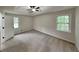 Spacious bedroom with plush carpeting, a tray ceiling, and a ceiling fan at 64 Little John Way, Douglasville, GA 30134