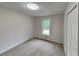 Bedroom features neutral paint and new carpet with a closet and a bright window at 64 Little John Way, Douglasville, GA 30134