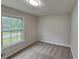 Bright bedroom features neutral carpeting and paint, and a window offering natural light at 64 Little John Way, Douglasville, GA 30134