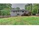 Back of house showing deck with stairs and fenced yard at 64 Little John Way, Douglasville, GA 30134