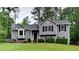 Charming gray two-story home with a well-manicured lawn and mature trees at 64 Little John Way, Douglasville, GA 30134