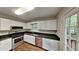 Modern kitchen featuring granite countertops, stainless steel appliances, and white cabinets at 64 Little John Way, Douglasville, GA 30134