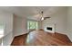 Spacious living room featuring hardwood floors, a fireplace, and bay windows at 64 Little John Way, Douglasville, GA 30134