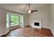 Bright living room with hardwood floors, fireplace, and large bay window at 64 Little John Way, Douglasville, GA 30134