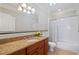 Well-appointed bathroom featuring granite countertops, a wood vanity, and a shower-tub combo with tile surround at 77 Peachtree Ne Pl # 608, Atlanta, GA 30309
