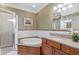 Bright bathroom featuring a soaking tub with granite counters, a glass-enclosed shower, and modern finishes at 77 Peachtree Ne Pl # 608, Atlanta, GA 30309