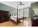 Bedroom with hardwood floors, four-poster bed and shuttered windows at 77 Peachtree Ne Pl # 608, Atlanta, GA 30309