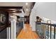 Elegant hallway with hardwood floors, dark wood trim, and wrought iron railings showcase upscale home design at 77 Peachtree Ne Pl # 608, Atlanta, GA 30309