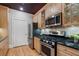 Galley kitchen with hardwood floors, granite counters, and stainless steel appliances at 77 Peachtree Ne Pl # 608, Atlanta, GA 30309