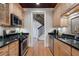 Galley kitchen with hardwood floors, granite counters, and stainless steel appliances at 77 Peachtree Ne Pl # 608, Atlanta, GA 30309