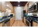 Galley kitchen featuring granite countertops and stainless steel appliances at 77 Peachtree Ne Pl # 608, Atlanta, GA 30309