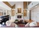 Elegant living room with a fireplace, piano, and built-in shelving at 77 Peachtree Ne Pl # 608, Atlanta, GA 30309