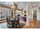 Open-concept living and dining area with elegant columns and hardwood flooring at 77 Peachtree Ne Pl # 608, Atlanta, GA 30309
