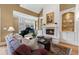 Elegant living room featuring a fireplace, piano, and beautiful hardwood floors at 77 Peachtree Ne Pl # 608, Atlanta, GA 30309