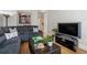 Inviting living room featuring a comfortable sectional sofa, hardwood floors, and modern media setup at 77 Peachtree Ne Pl # 608, Atlanta, GA 30309