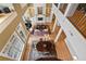 Open-concept living area featuring high ceilings, a fireplace, a dining area, and large windows at 77 Peachtree Ne Pl # 608, Atlanta, GA 30309