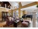 Elegant living room featuring a fireplace, piano, soaring ceilings, and hardwood floors at 77 Peachtree Ne Pl # 608, Atlanta, GA 30309