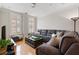 Comfortable living room with a large sectional sofa, hardwood floors, and natural light from shuttered windows at 77 Peachtree Ne Pl # 608, Atlanta, GA 30309