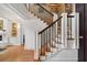 Elegant staircase featuring wooden steps, wrought iron railings, and decorative trim at 77 Peachtree Ne Pl # 608, Atlanta, GA 30309