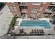 Top-down view of a rectangular swimming pool surrounded by lounge chairs in a courtyard at 77 Peachtree Ne Pl # 608, Atlanta, GA 30309