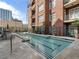 Outdoor swimming pool with surrounding lounge area and views of the city skyline; ideal for leisure at 77 Peachtree Ne Pl # 608, Atlanta, GA 30309