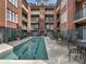 Exterior courtyard featuring a lap swimming pool with lounge chairs and tables; great for relaxing at 77 Peachtree Ne Pl # 608, Atlanta, GA 30309