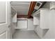 Walk-in closet with built-in shelving units and hardware at 1261 Caroline Street Ne # 206, Atlanta, GA 30307