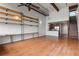 Open concept living area featuring wood floors, shelving, and stairs to upper level at 1261 Caroline Street Ne # 206, Atlanta, GA 30307