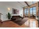 Spacious living room featuring exposed brick and large windows offering ample natural light at 1261 Caroline Street Ne # 206, Atlanta, GA 30307