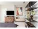 Relaxing bedroom featuring a comfy chaise lounge, mounted TV and a striking piece of art, a stylish retreat at 1371 Walking Way, Atlanta, GA 30316