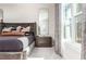 Comfortable bedroom featuring a tufted headboard, full-length mirror and neutral color palette, creating a cozy retreat at 1371 Walking Way, Atlanta, GA 30316
