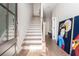Bright entryway features a staircase, light wood floors, and stylish art on the wall at 1371 Walking Way, Atlanta, GA 30316