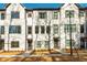 Beautiful new construction townhome with painted brick, dark trim and a sidewalk leading to the front door at 1371 Walking Way, Atlanta, GA 30316