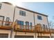 Rear exterior view of townhomes featuring private wooden decks, garage, and neutral siding at 1371 Walking Way, Atlanta, GA 30316