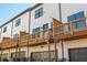Shot of townhouses with individual wooden decks, garage doors, and white siding, offering comfortable outdoor living at 1371 Walking Way, Atlanta, GA 30316