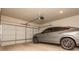 Clean garage with modern gray car parked inside and a white garage door at 1371 Walking Way, Atlanta, GA 30316