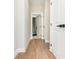 Hallway with wood floor and white doors with black door hardware at 1371 Walking Way, Atlanta, GA 30316
