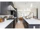 Modern kitchen features an island with sink, white marble counters, and stainless appliances at 1371 Walking Way, Atlanta, GA 30316