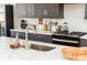Close-up of the kitchen island with a stainless steel sink and marble countertop at 1371 Walking Way, Atlanta, GA 30316