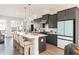 Modern kitchen features an island with seating, stainless steel appliances, and gray cabinetry at 1371 Walking Way, Atlanta, GA 30316