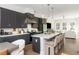 Open kitchen with gray cabinets, marble counters, stainless appliances, and seating at the island at 1371 Walking Way, Atlanta, GA 30316
